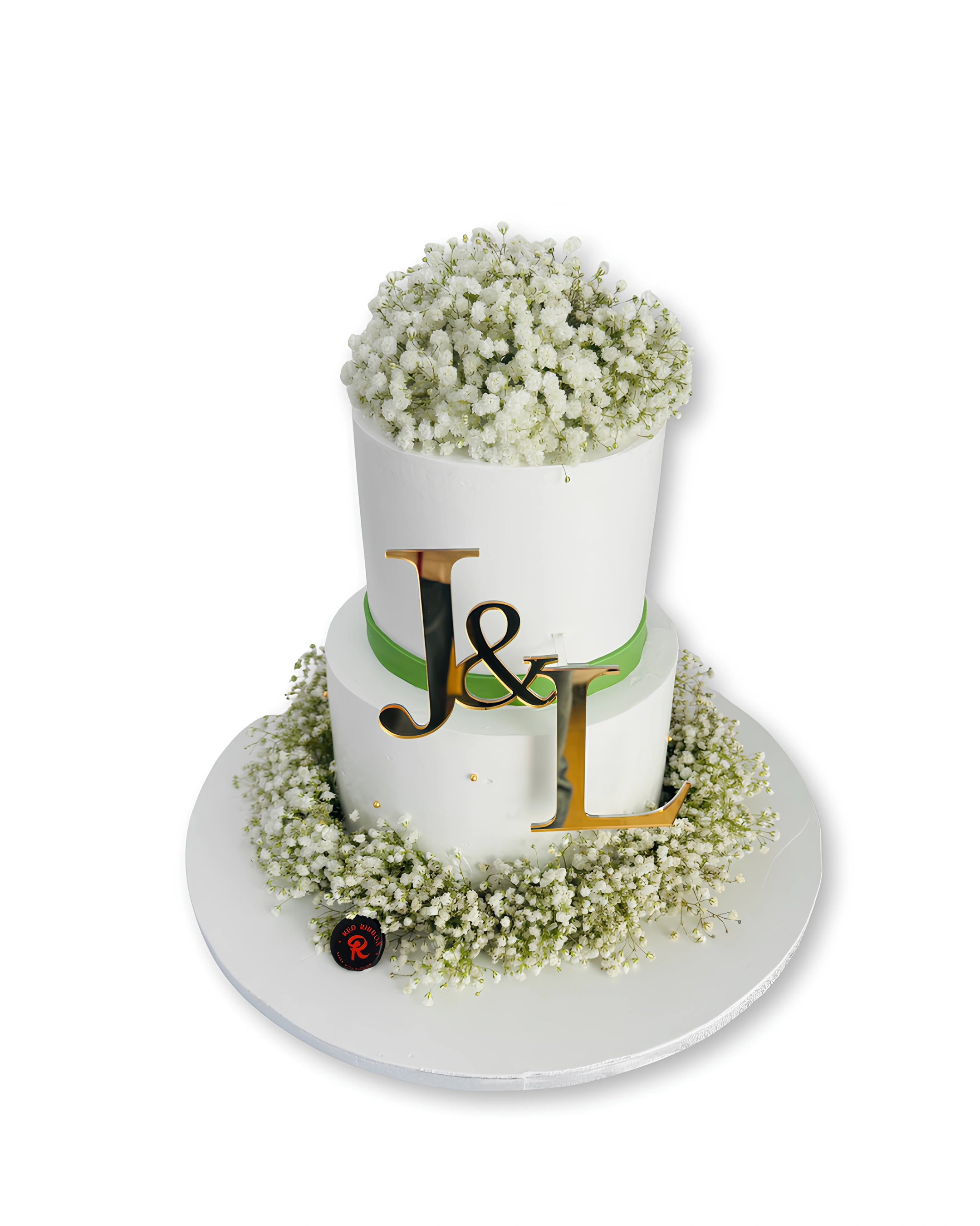 Elegant floral wedding cake with white flowers and custom initials topper, modern wedding cake by Red Ribbon Cakes in Dubai