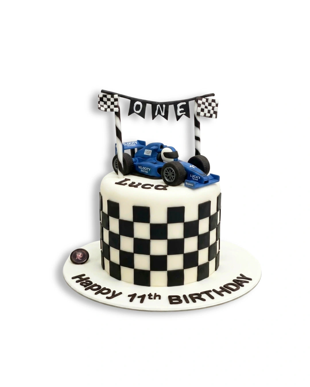Racing finish line themed cake by Red Ribbon Cakes with checkered pattern and race car elements, custom birthday cake in Dubai