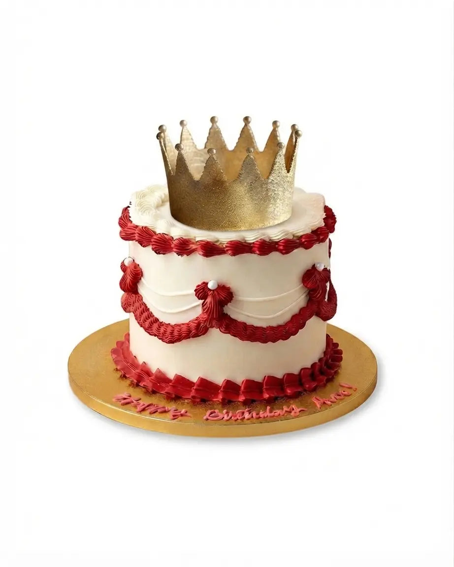 Royal majesty wedding cake with crown topper and red decorative piping, luxury wedding cake by Red Ribbon Cakes in Dubai